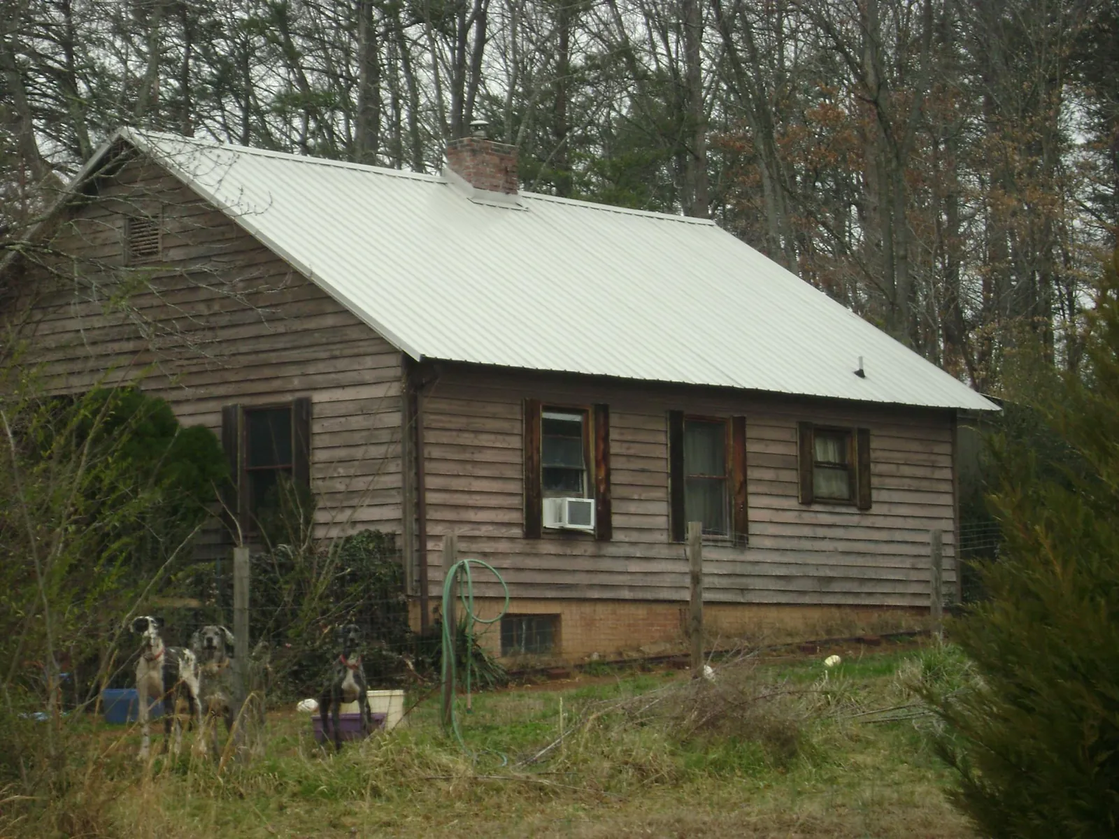 White metal roof on an old wood sided farmhouse, from a Metal Roof Installation job in Jessup